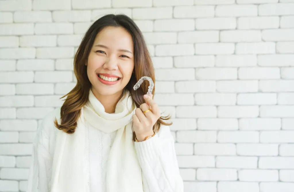a woman holding a clear plastic object