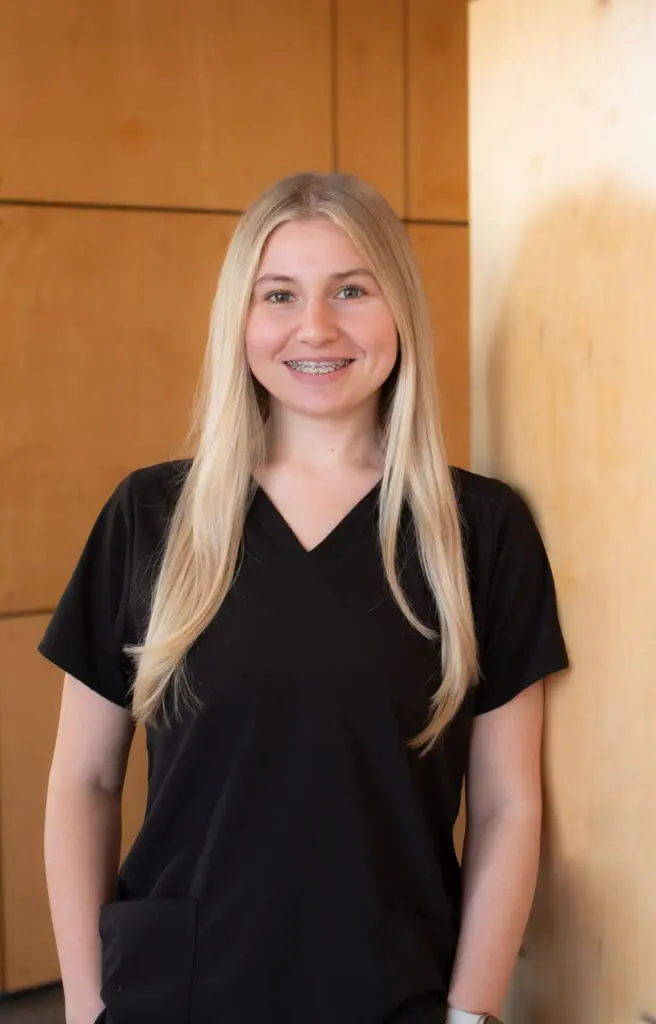 a woman with braces smiling