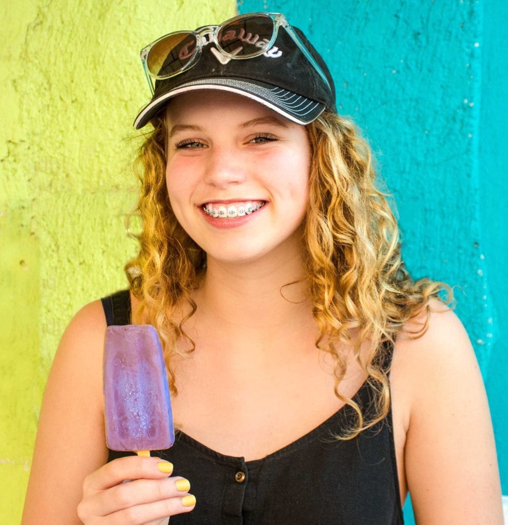 woman with braces eating a popsicle