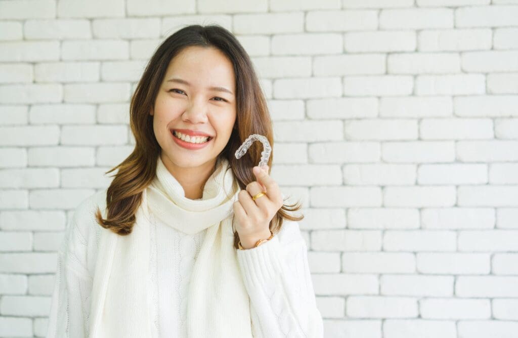 a woman holding a clear plastic object