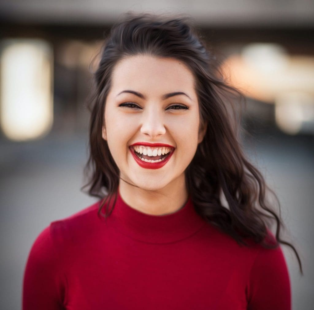 Woman smiling in red sweater